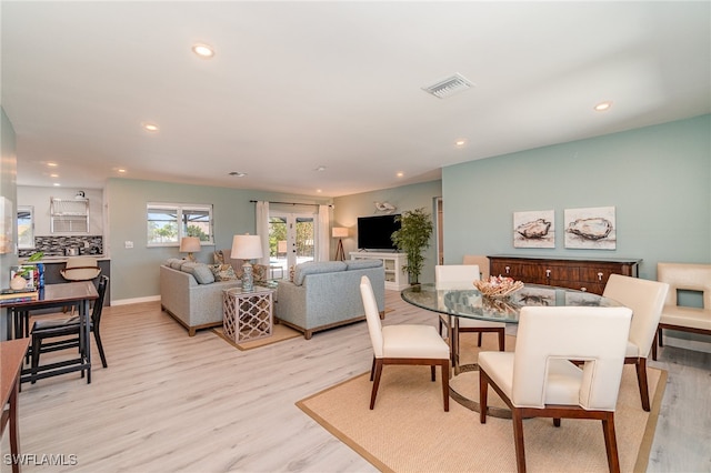 dining room featuring light hardwood / wood-style floors and french doors