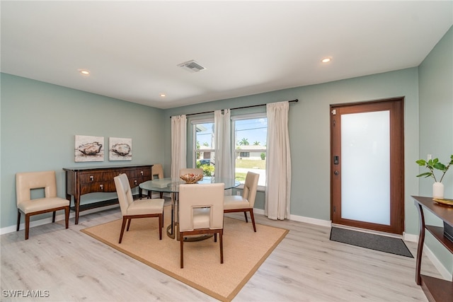 dining space with light hardwood / wood-style flooring