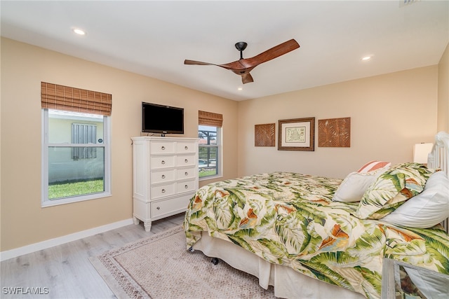 bedroom with ceiling fan and light hardwood / wood-style flooring