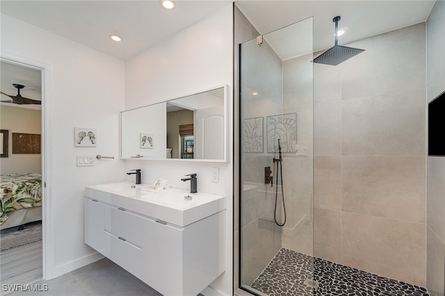 bathroom featuring vanity and tiled shower