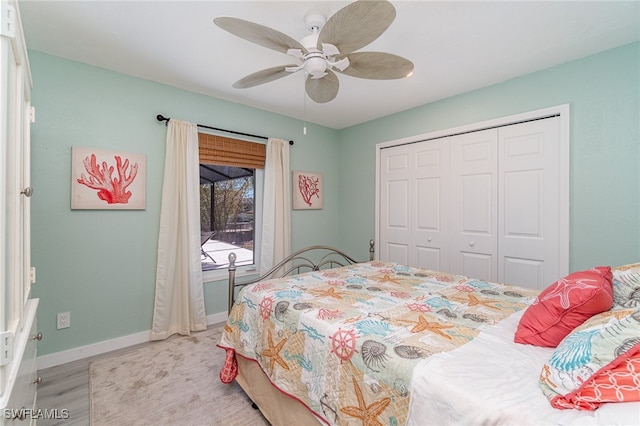 bedroom featuring ceiling fan, light wood-type flooring, and a closet