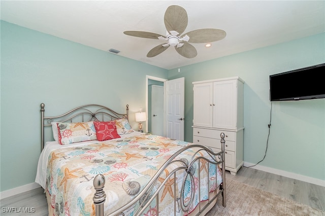 bedroom with ceiling fan and light hardwood / wood-style flooring