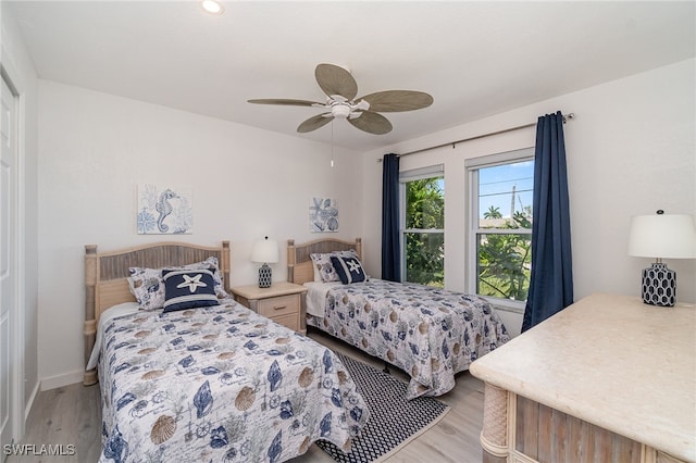 bedroom with ceiling fan and light hardwood / wood-style floors