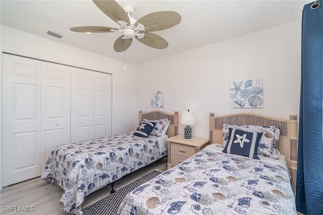 bedroom with a closet, ceiling fan, and light hardwood / wood-style floors