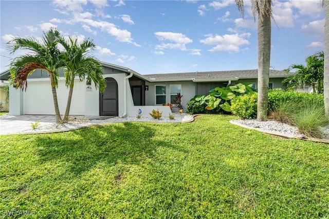 ranch-style house featuring a garage and a front lawn