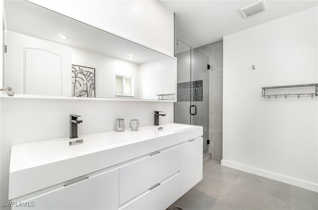 bathroom with vanity and a shower with shower door