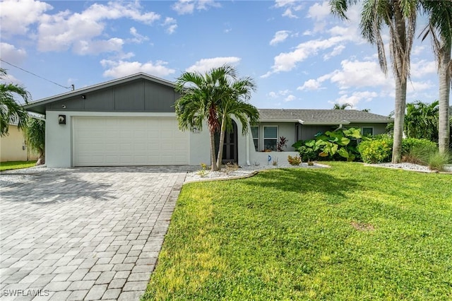 ranch-style home featuring a garage and a front lawn