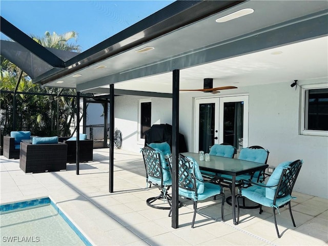 view of patio with ceiling fan, an outdoor living space, glass enclosure, and french doors