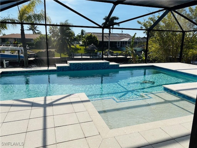 view of pool featuring a patio area and a lanai