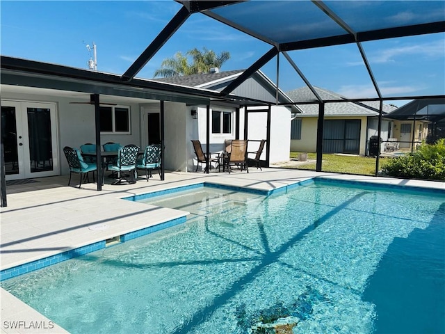 view of pool with a lanai, ceiling fan, and a patio area