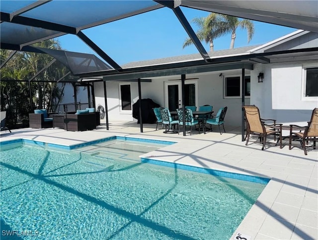 view of pool featuring outdoor lounge area, french doors, ceiling fan, a lanai, and a patio area