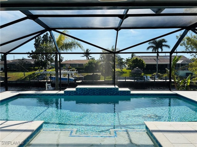 view of swimming pool featuring glass enclosure