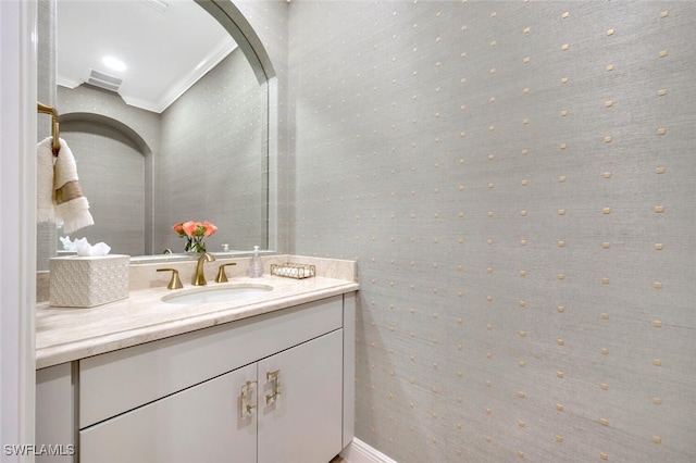 bathroom with vanity and ornamental molding