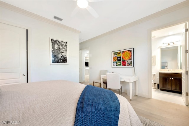 bedroom featuring ornamental molding, ensuite bathroom, light hardwood / wood-style floors, and ceiling fan