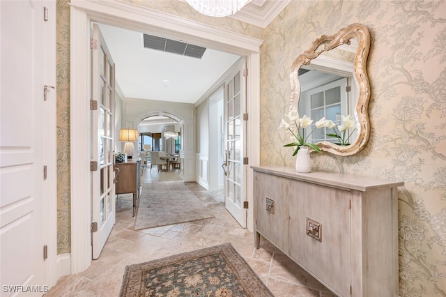 hall featuring crown molding and french doors