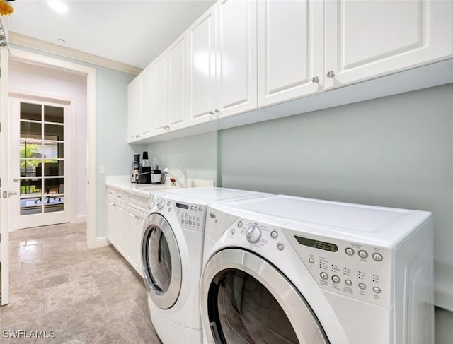 laundry area featuring sink, washing machine and dryer, and cabinets