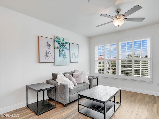 living room featuring ceiling fan, a healthy amount of sunlight, and light wood-type flooring