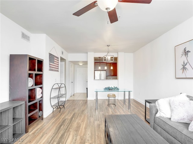 living room with ceiling fan and light hardwood / wood-style floors