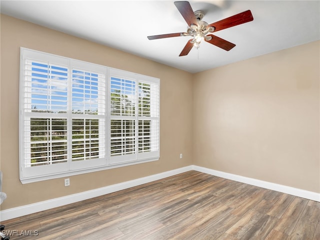 empty room with ceiling fan and wood-type flooring