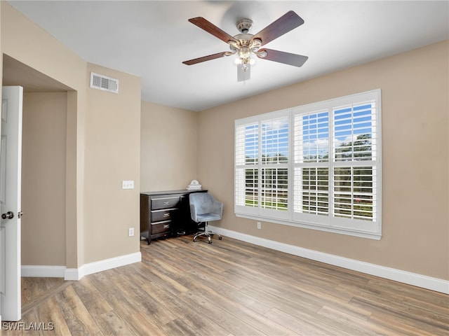 unfurnished office featuring ceiling fan and light hardwood / wood-style flooring