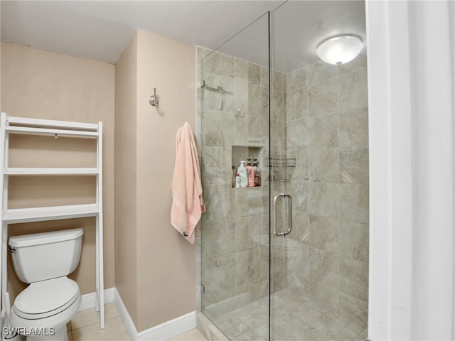 bathroom featuring toilet, tile patterned floors, and walk in shower