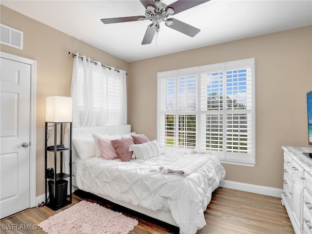 bedroom with light wood-type flooring and ceiling fan