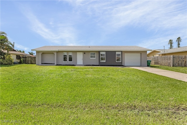 ranch-style home featuring a garage and a front lawn