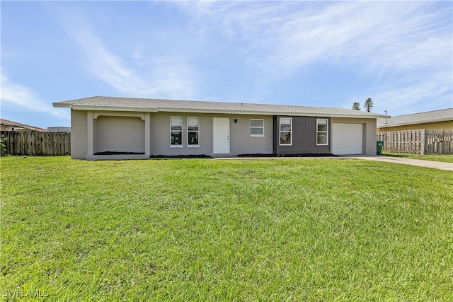 ranch-style house with a garage and a front lawn