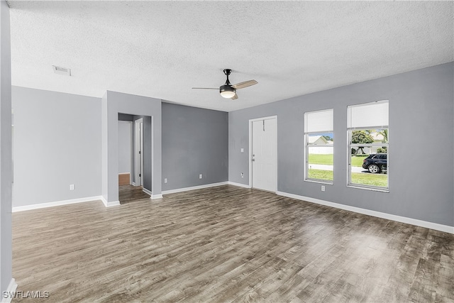 unfurnished room featuring a textured ceiling, ceiling fan, and hardwood / wood-style floors