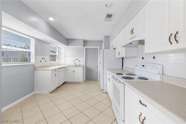 kitchen with white appliances, light tile patterned floors, backsplash, sink, and white cabinetry