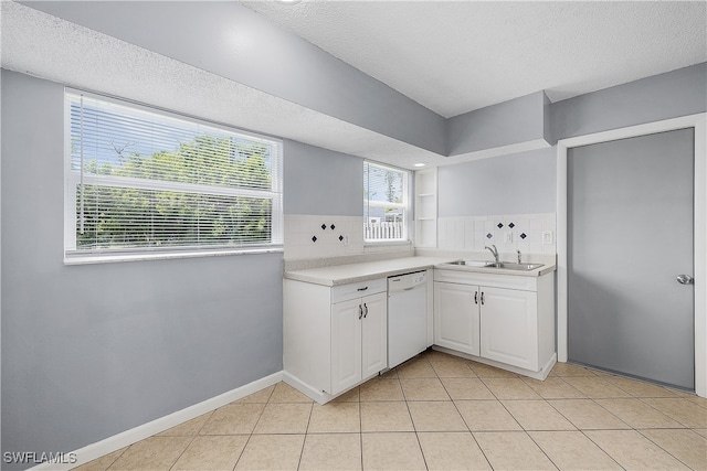 kitchen featuring a healthy amount of sunlight, dishwasher, and tasteful backsplash