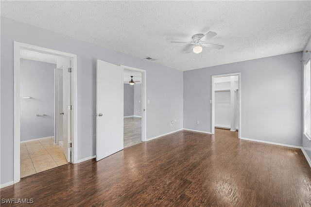 unfurnished room with a textured ceiling, ceiling fan, and hardwood / wood-style floors