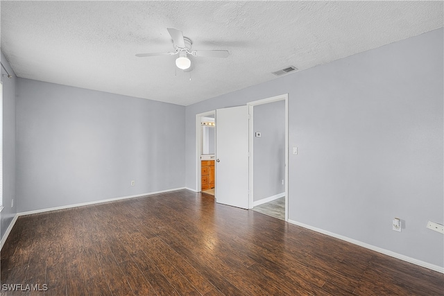 spare room featuring a textured ceiling, ceiling fan, and dark hardwood / wood-style floors