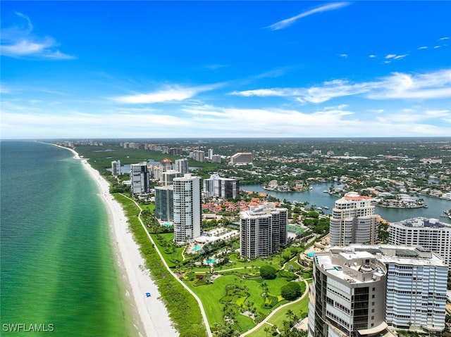 aerial view featuring a water view, a beach view, and a city view