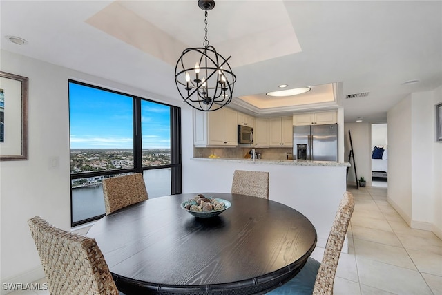 dining space featuring light tile patterned floors, baseboards, visible vents, a raised ceiling, and recessed lighting