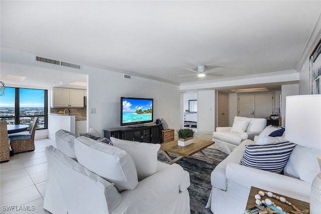 living room featuring light tile patterned floors, visible vents, and a ceiling fan