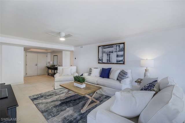 living room with ornamental molding, ceiling fan, and light tile patterned floors