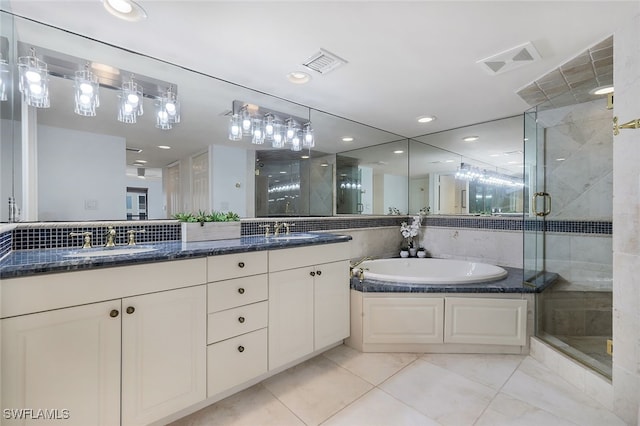 bathroom featuring a stall shower, visible vents, and a sink