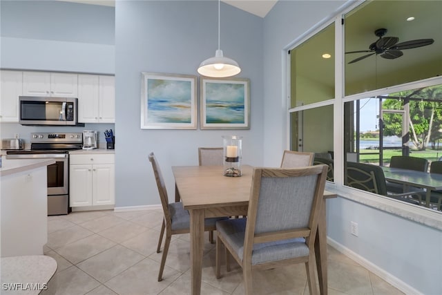 dining area with ceiling fan and light tile patterned floors