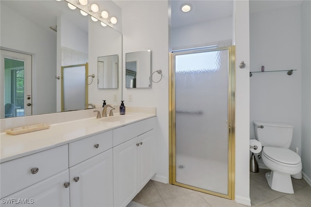 bathroom with vanity, toilet, a healthy amount of sunlight, and a shower with door