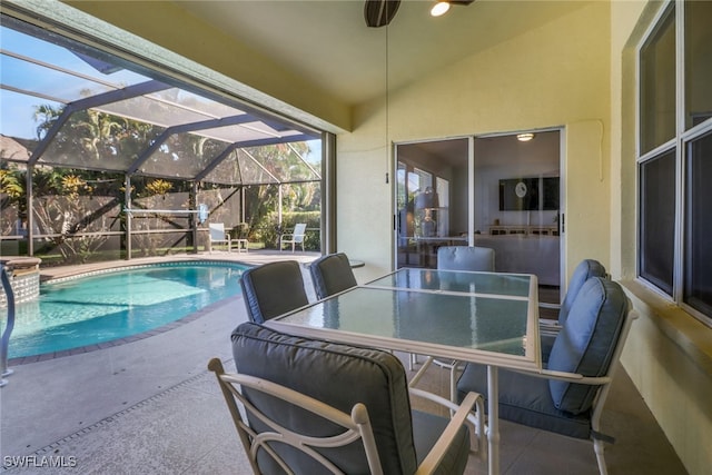 view of pool featuring a lanai, a patio area, and ceiling fan