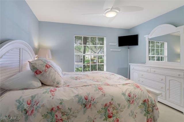 bedroom with light colored carpet and ceiling fan