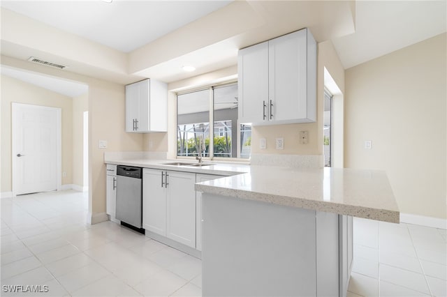 kitchen featuring light stone countertops, white cabinets, dishwasher, kitchen peninsula, and light tile patterned floors