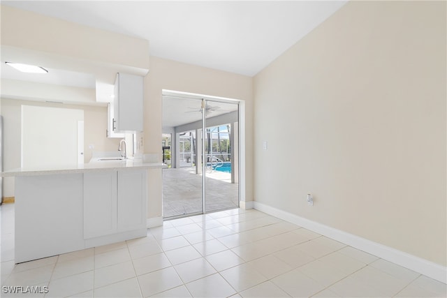 empty room with light tile patterned floors and sink