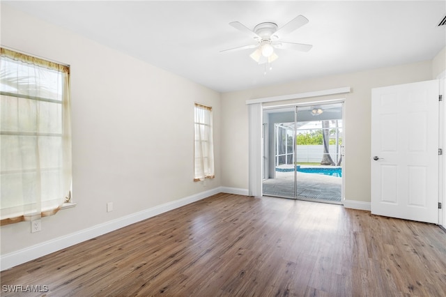 unfurnished room with ceiling fan and hardwood / wood-style floors