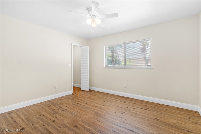 empty room with ceiling fan and light wood-type flooring