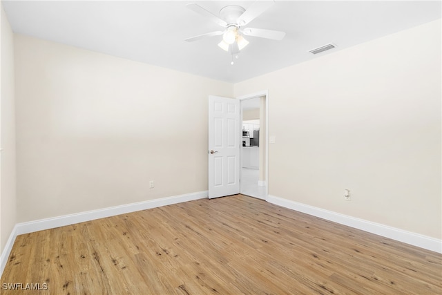 empty room featuring ceiling fan and light hardwood / wood-style flooring