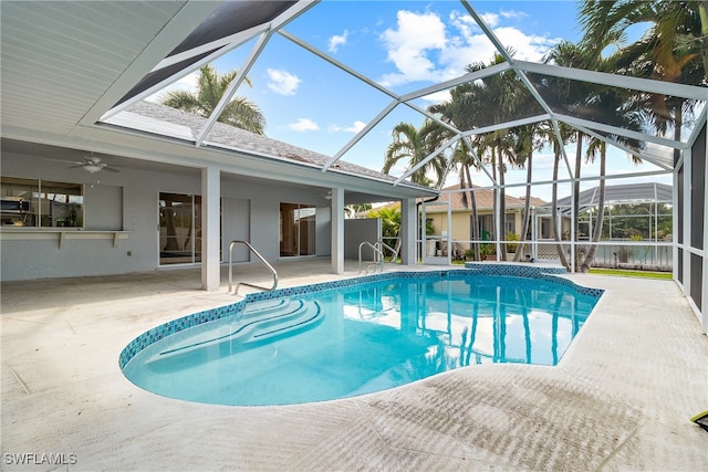 view of pool with a lanai, ceiling fan, and a patio