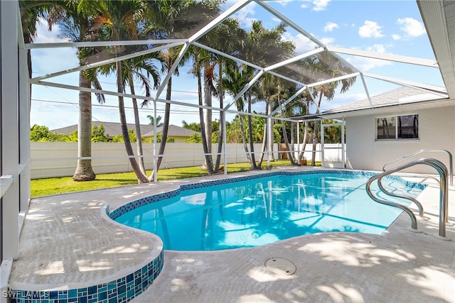 view of pool featuring glass enclosure and a patio