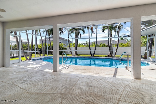 view of swimming pool with a lanai and a patio